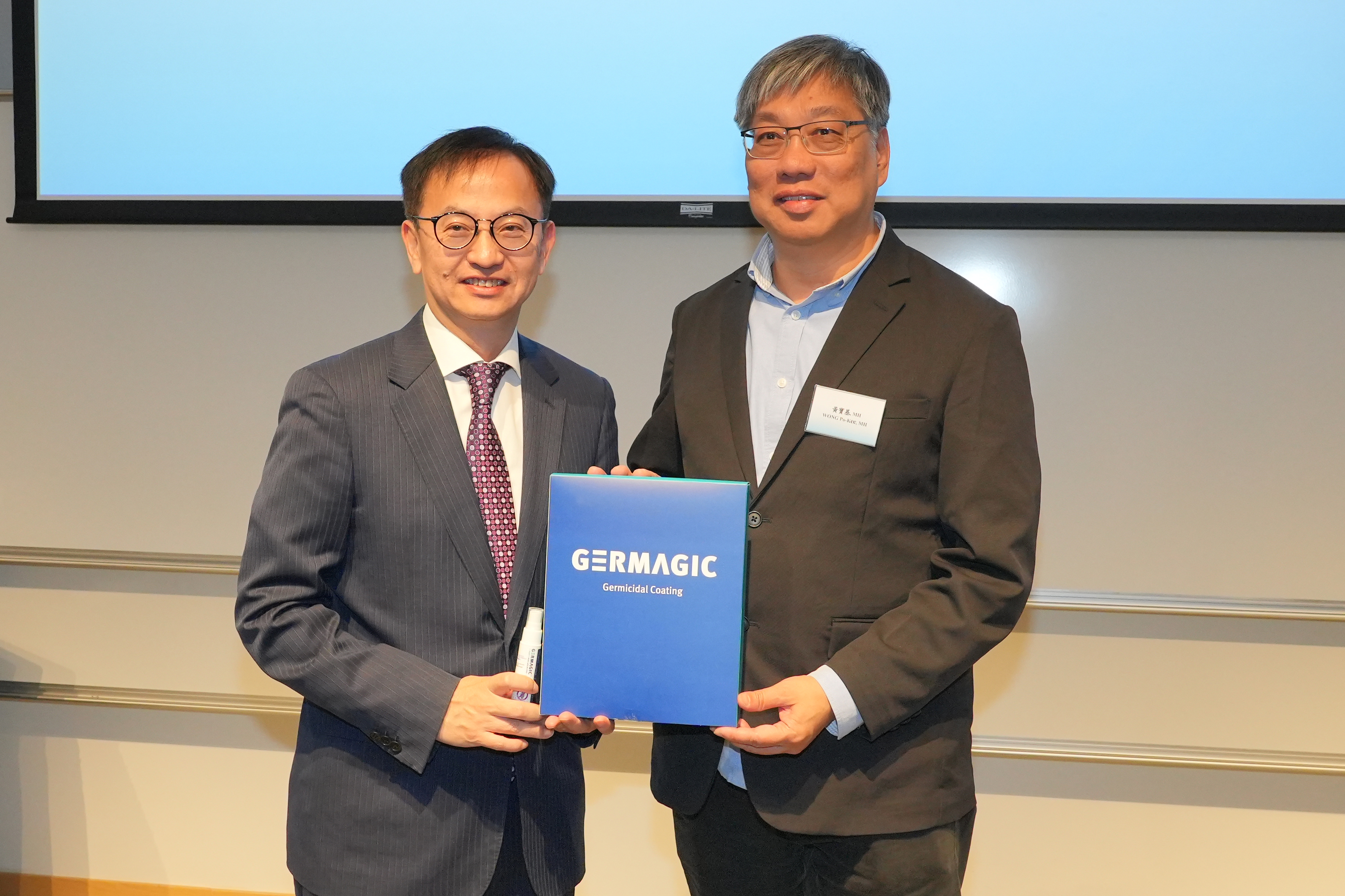 Dr. David CHUNG (left) presents the pest repellent developed by the lab as a souvenir to Mr. WONG Po-Kee, Honorary Deputy Secretary General of the Sports Federation & Olympic Committee of Hong Kong, China (right). 