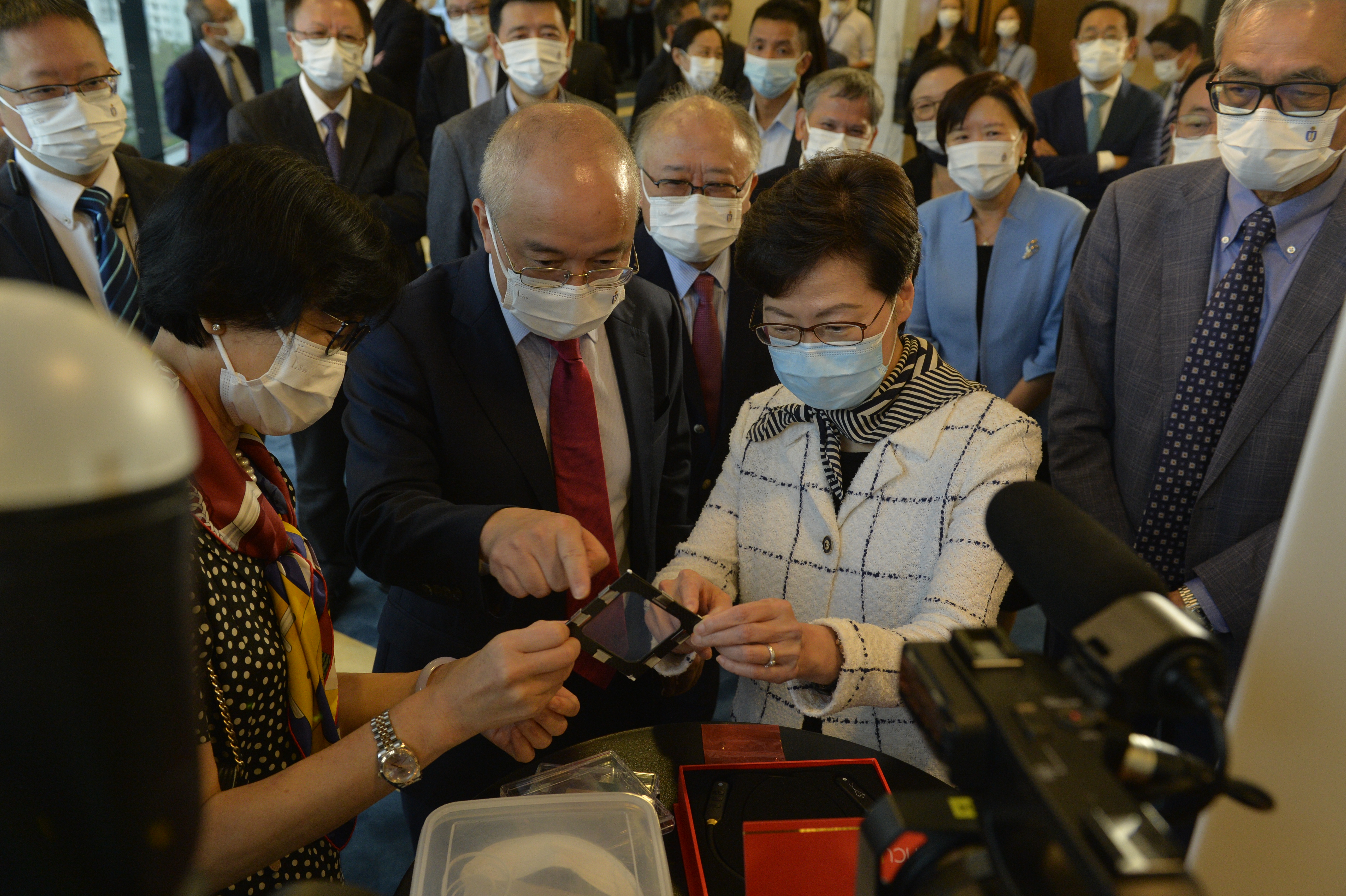 Prof. Gao Ping (left) explains her recent development of the world's strongest polymer nanomembrane and how this novel material can be used to build a transparent and breathable face mask.