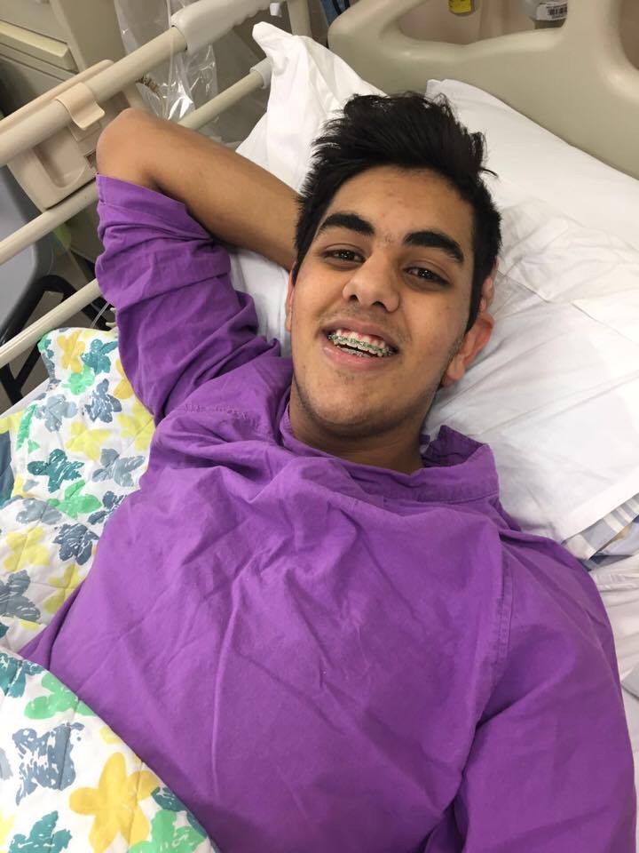 KJ lying on bed in hospital